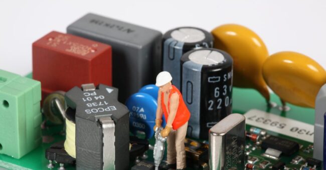 Man mending PCB Greasley Electronic Repairs, Service & Repair, Food Manufacturing, Power Supply Repair,Aerospace PCB Repairs in the Midlands